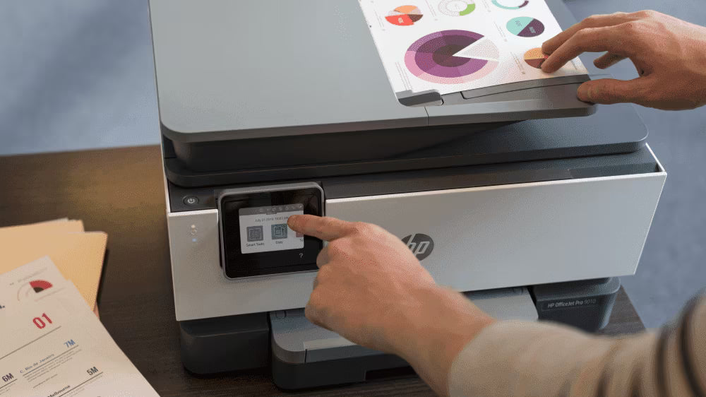 Person using a HP printer with a tablet on top