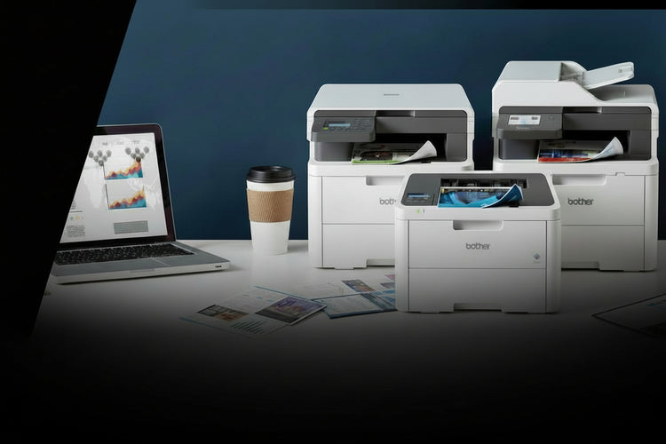 Two printers on a desk with a laptop displaying a document, coffee cup, and magazine.